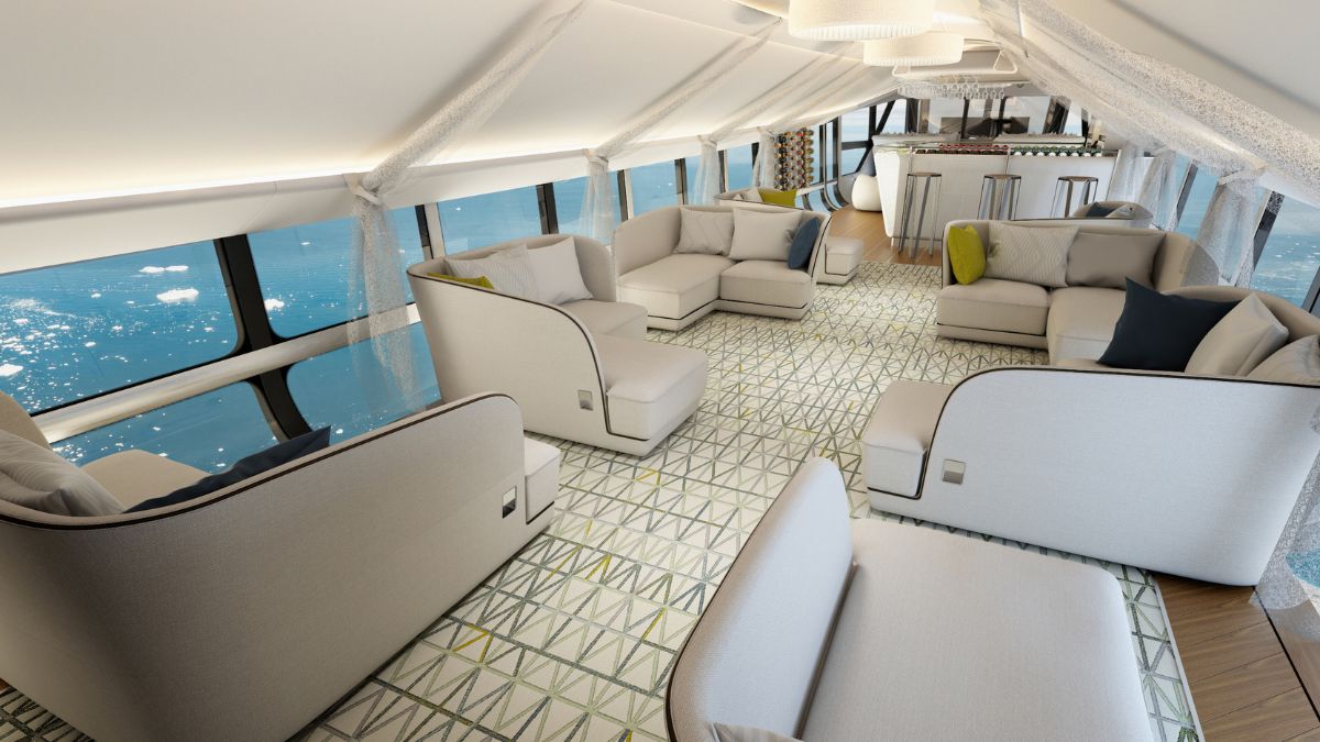 A spacious and modern lounge area with plush white sofas and colorful cushions, large panoramic windows showcasing a view of the ocean, and stylish decor elements throughout.