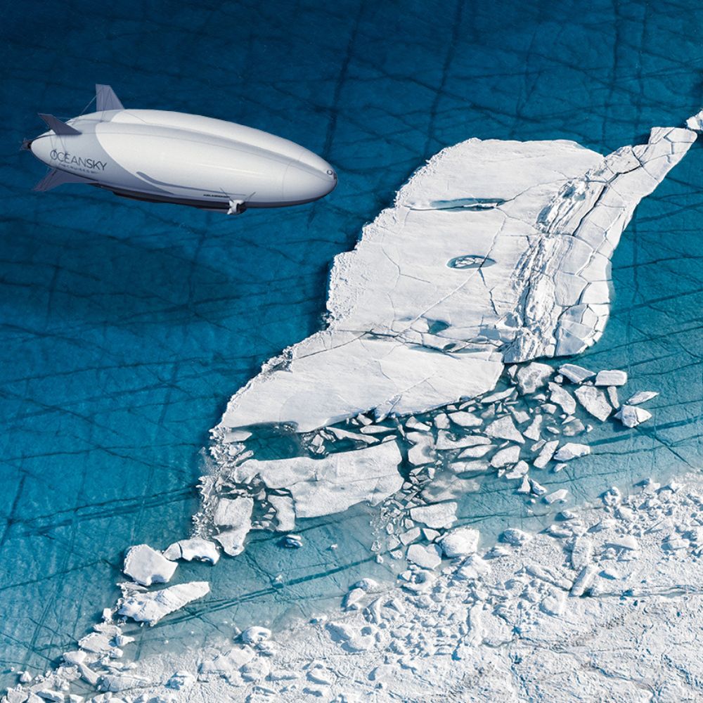 A futuristic airship flies over a large, fragmented ice formation in a deep blue sea. The ice has cracks and textures, contrasting with the smooth surface of the water below.