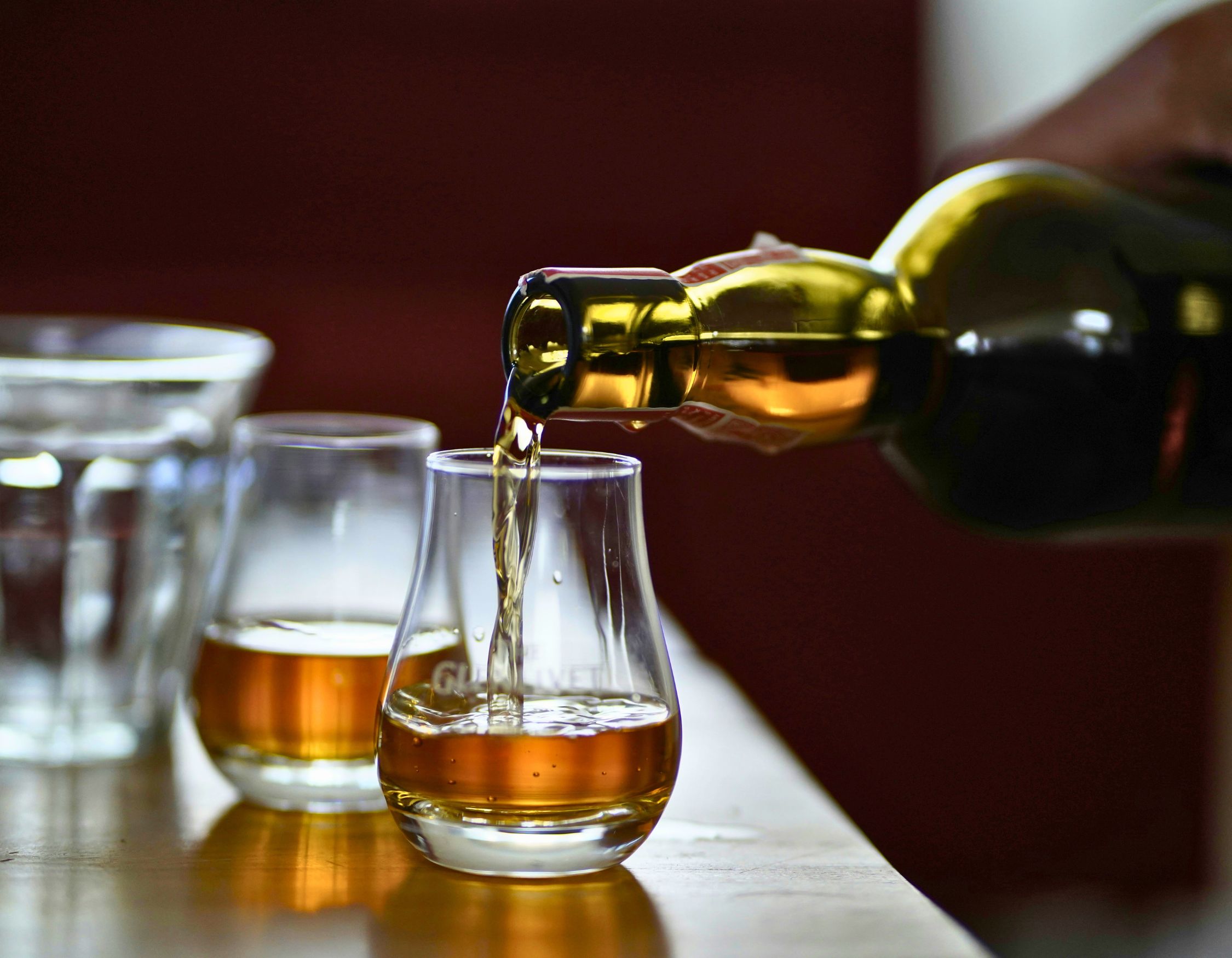 whiskey getting poured into two glasses