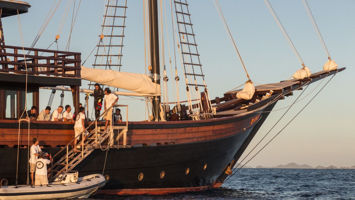 Traditional luxury phinisi yacht in Raja Ampat during sunset boarding