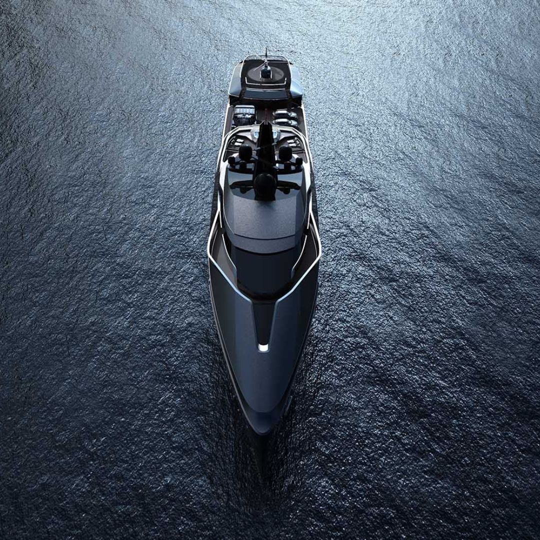 A sleek, modern yacht with a dark exterior gliding over calm blue waters, captured from a high aerial view.