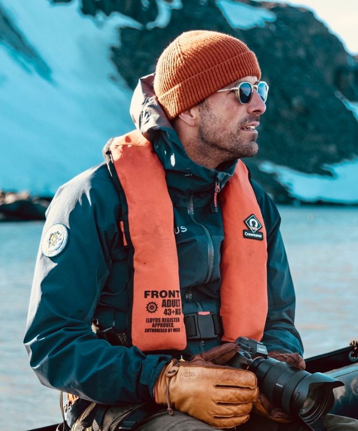 Man holding a camera on a boat in Antarctica