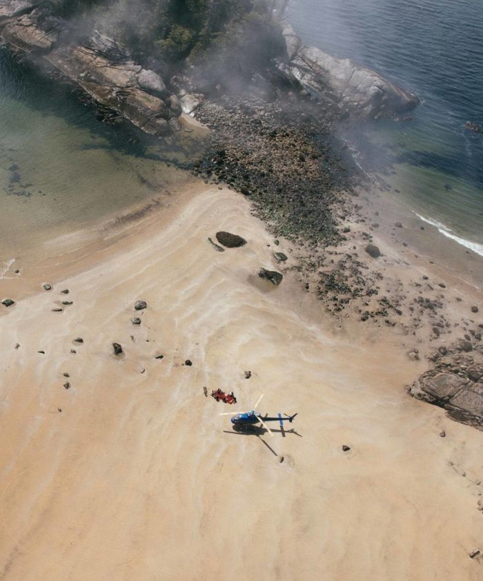 helicopter on a beach in british columbia as part of a luxury experiential travel experience