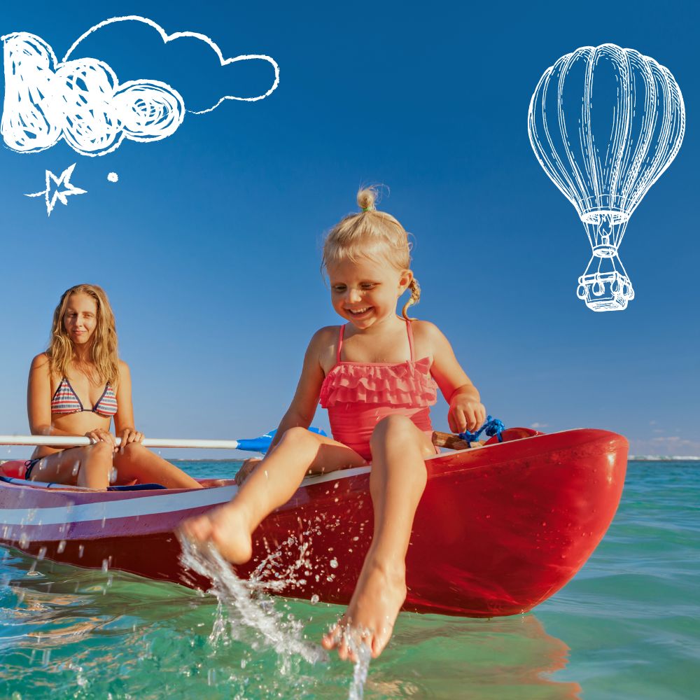 A young girl in a red kayak splashes water with her feet while smiling at the camera. A woman sits behind her, enjoying the sunny day. The background features a clear blue sky with clouds and a sketched hot air balloon.