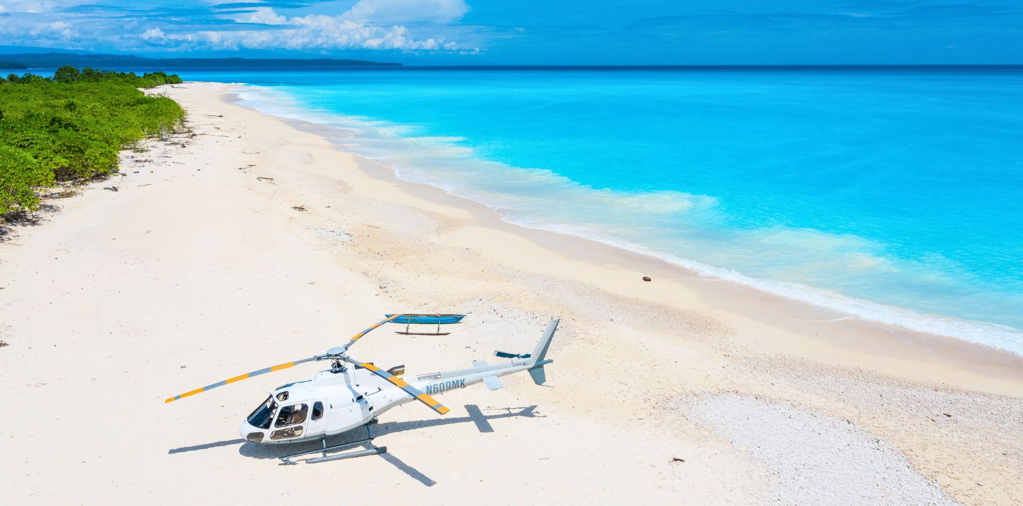 private helicopter on secluded sandy beach in papua new guinea as part of a luxury travel concierge experience