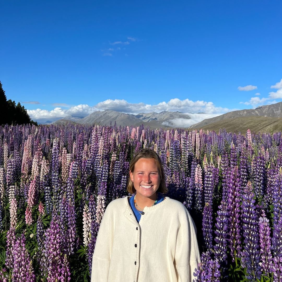 Molly Bradach standing amongst the flowers in New Zealand