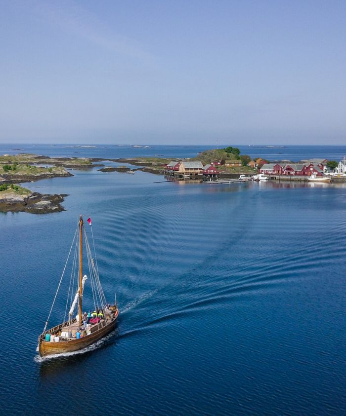 Boat sailing calm blue fjord in Norway