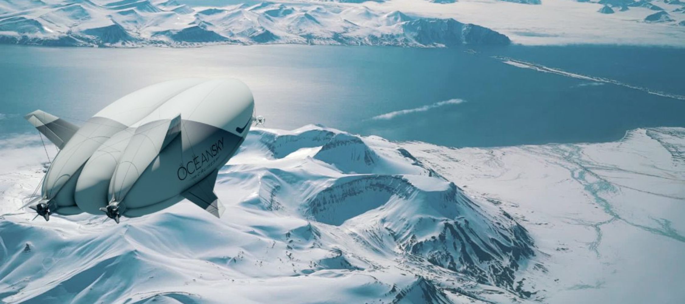 A futuristic airship glides over snow-covered mountains and a tranquil body of water, under a clear blue sky. The airship features a sleek design with the word "OCEANASY" prominently displayed on its side.
