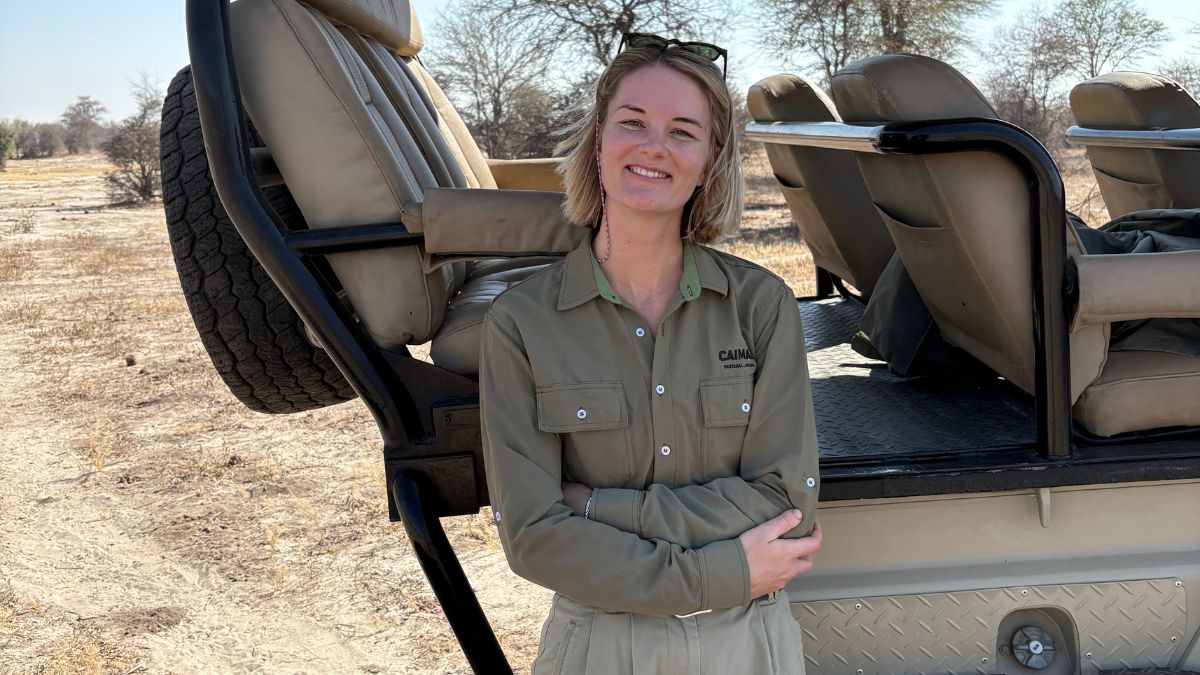 Savannah stood by a safari car