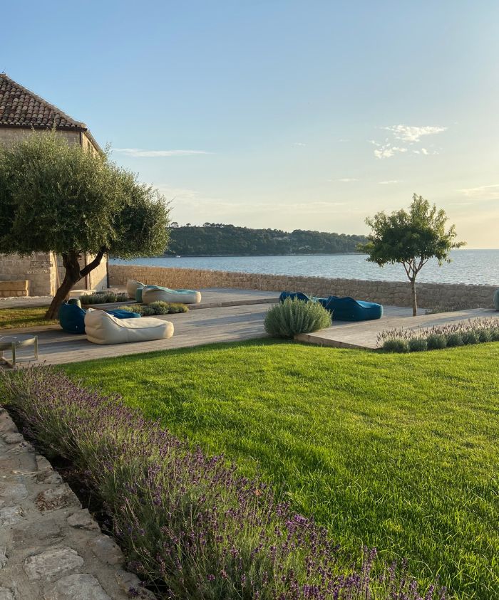 soft loungers and garden overlooking the sea