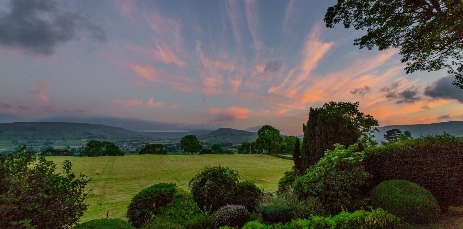 A sunset over the rolling hills on a luxury UK vacation