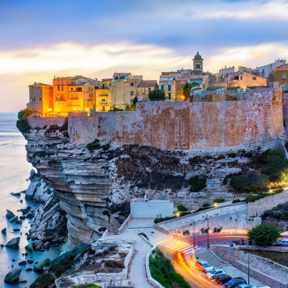 Cliffside village of Bonifacio at sunset, one of the best places to visit in the South of France
