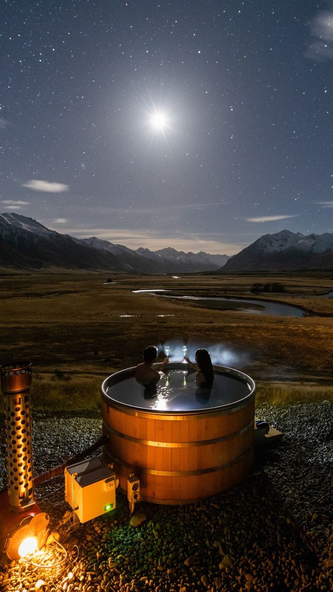 Couple stargazing from a hot tub