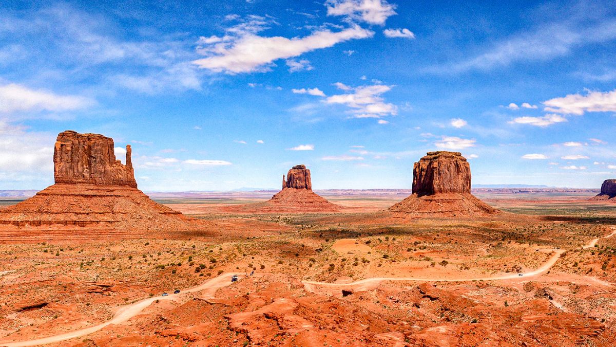 Sweeping desert views and towering rock formations in Monument Valley - an iconic landscape that makes the it one of the best places to visit in July USA