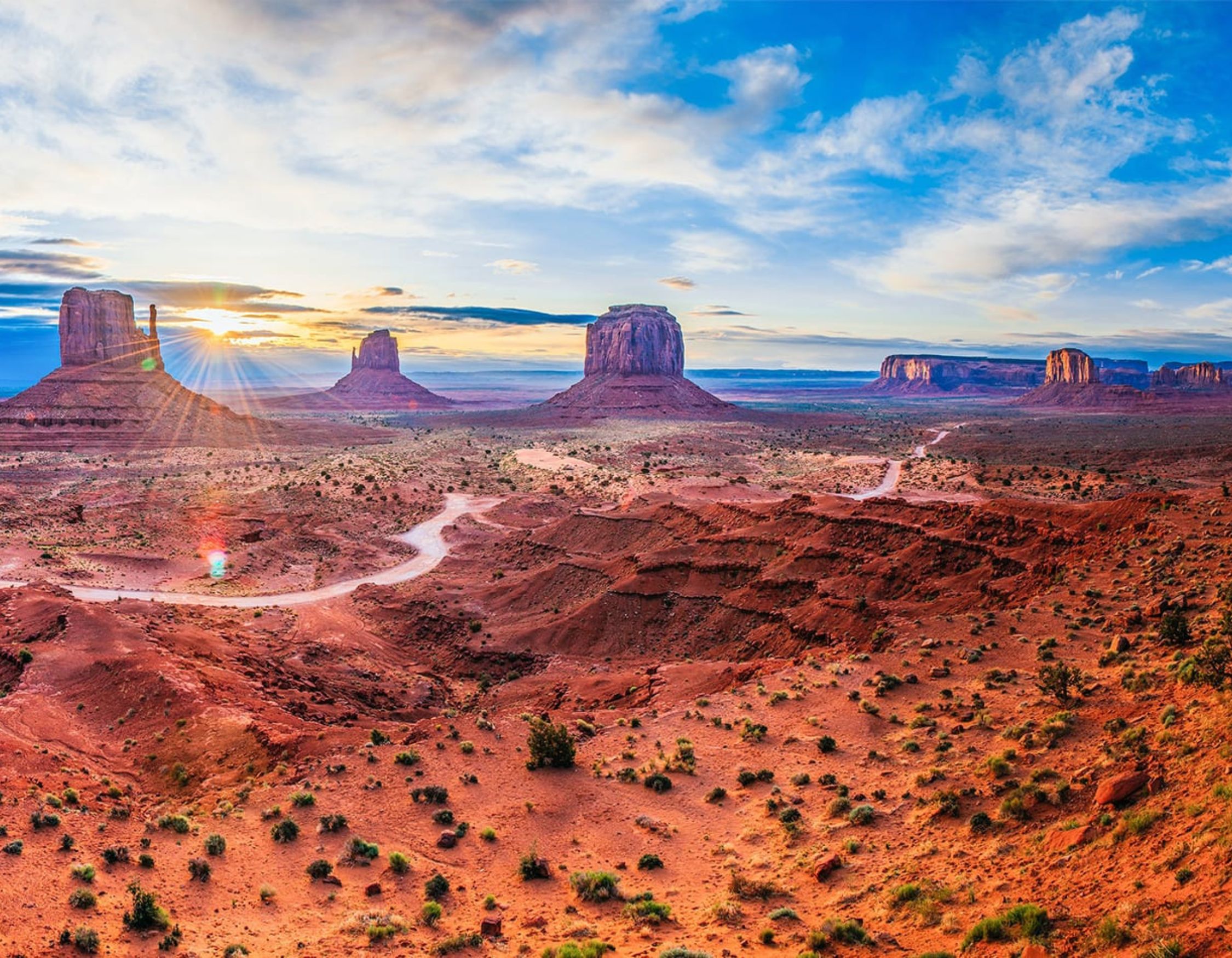 Sunrise over Monument Valley’s red rock buttes on a Colorado to Utah road trip