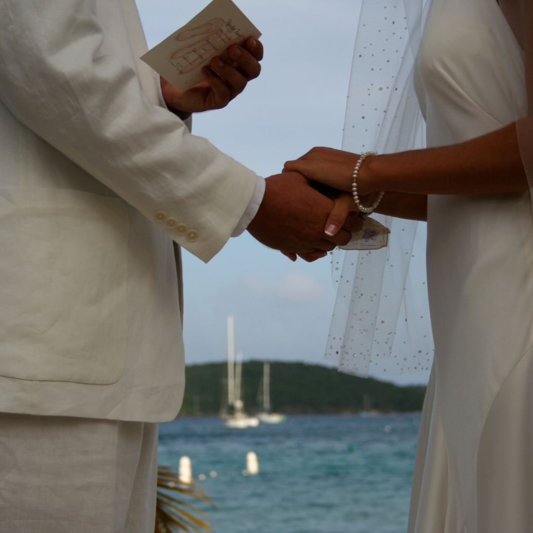 Couple exchanging vows during a private wedding ceremony at sea, yacht wedding charter